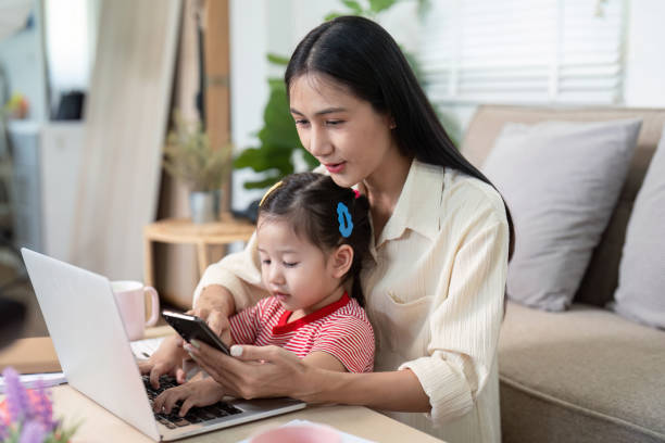 istock Connected Mother and Daughter Using Devices at Home 2170914787