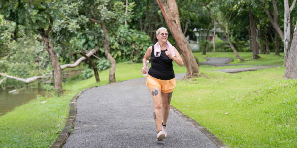 istock Energetic Older Woman Running in Scenic Park Pathway 2170914842