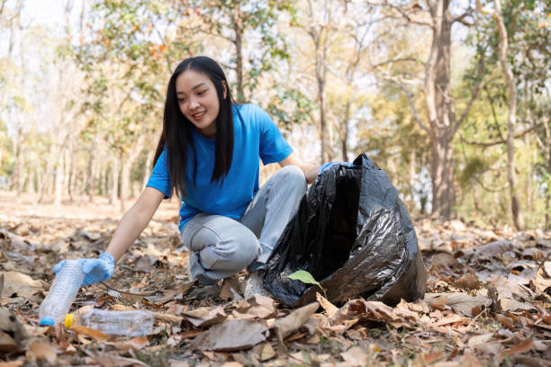 istock Woman Picking Litter with Bag in Leafy Forest 2170917216