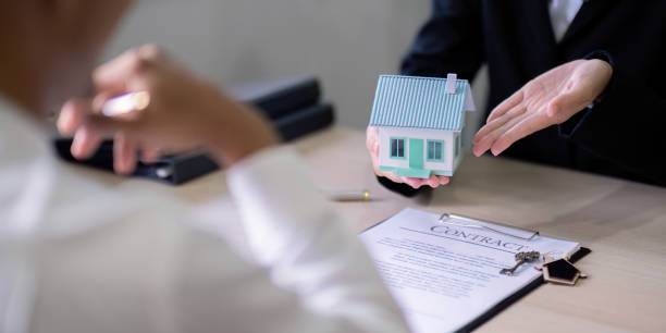 istock Real Estate Agent Presenting House Model to Client for Sale 2170917439