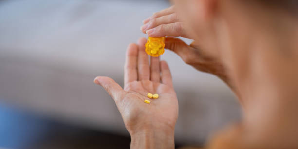 istock Elderly Woman Pouring Pills from Bottle for Daily Medication 2170917536