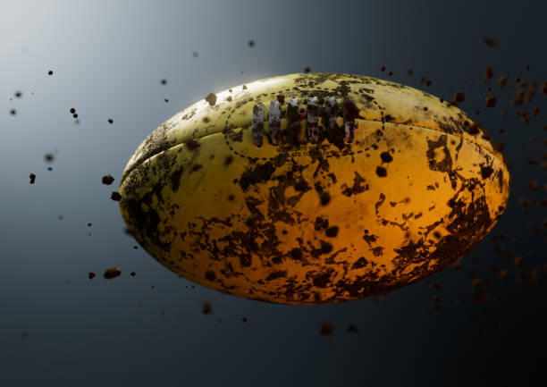 A muddy dirty australian rules football ball caught in slow motion flying through the air scattering mud particles in its wake - 3D render