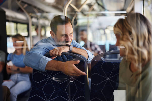 istock Happy man talking to female passenger in a bus. 2170919089