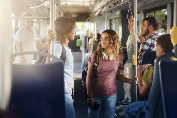 istock Happy students talking while traveling to school in a bus. 2170919199