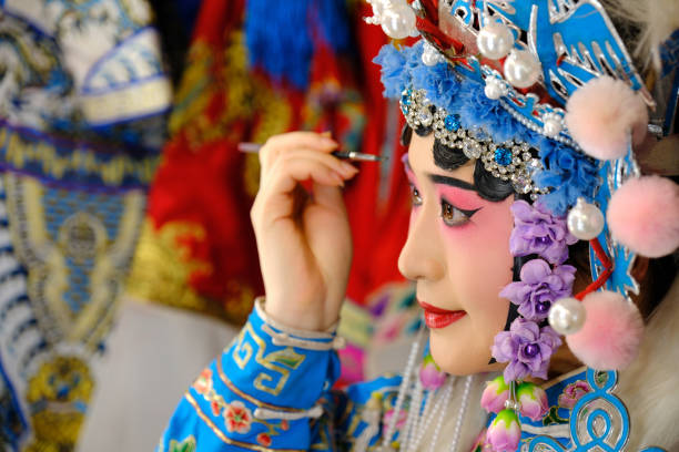 istock A Beijing opera actress is making up before a mirror 2170919825