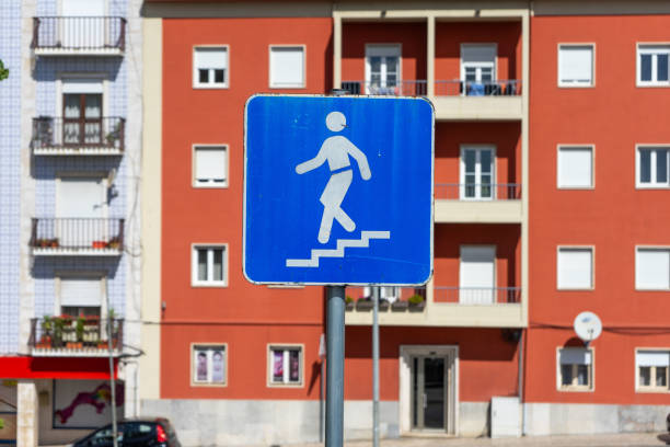 Street sign indicating stairs, guiding pedestrians safely. Ideal for urban navigation and cityscape themes.
