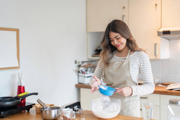 istock Asian woman enjoying baking with precision in stylish kitchen 2170922242