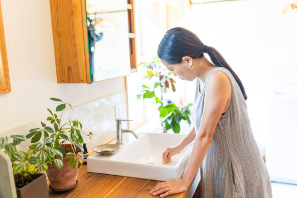 istock Young woman cleaning home bathroom sink 2170923736