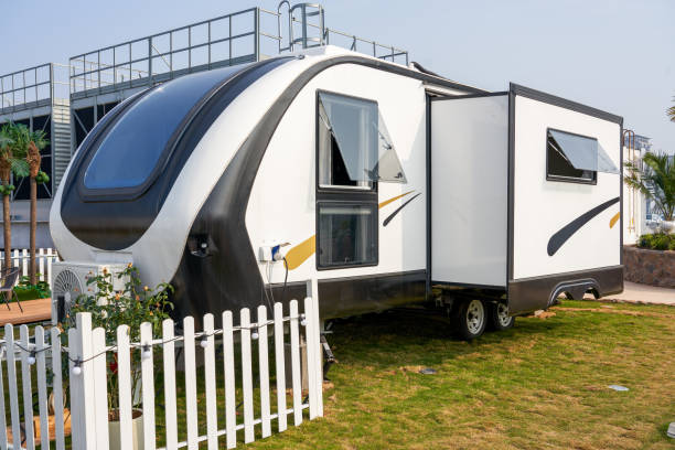 Ground view of a fifth wheel camper trailer in a wooded campsite