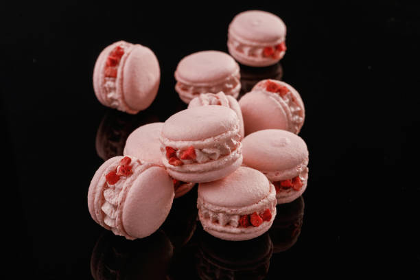 istock Pink color. Macarons on the black surface 2170927160