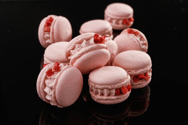 istock Pink color. Macarons on the black surface 2170927161