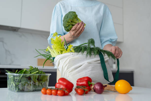 istock In a contemporary kitchen, a woman is unloading fresh groceries using ecofriendly bags 2170928796