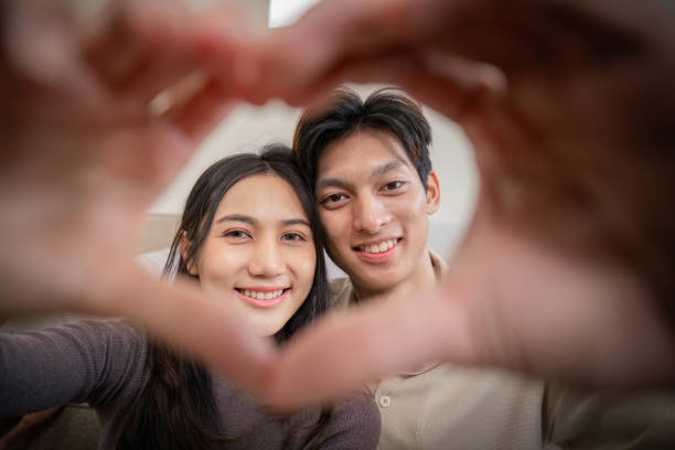 istock Young couple making a heart shape with their hands 2170929276