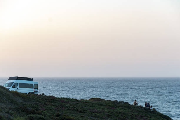 istock Sunset in a family's camper van on some cliffs by the sea 2170929534