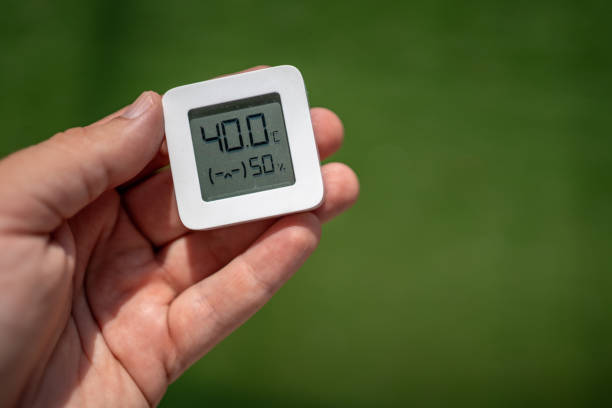 istock Hand holding small thermometer showing extreme high summer temperatures 2170930006