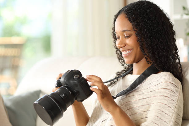 istock Happy photographer checking photos on camera at home 2170930376