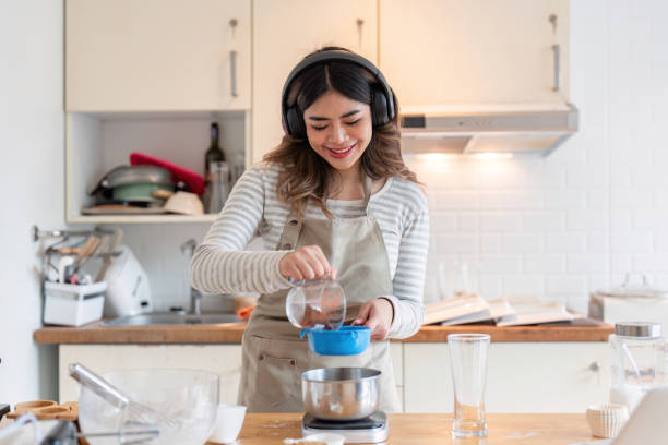 istock Pouring ingredients with musical inspiration in cozy kitchen 2170930577