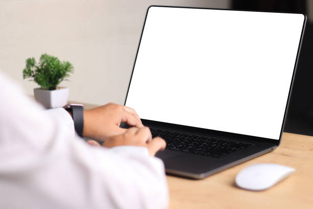 istock Mockup laptop computer. Business woman using laptop with empty screen on wooden table. 2170931003