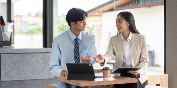 istock Business professionals discussing strategy at cafe with tablet 2170931216