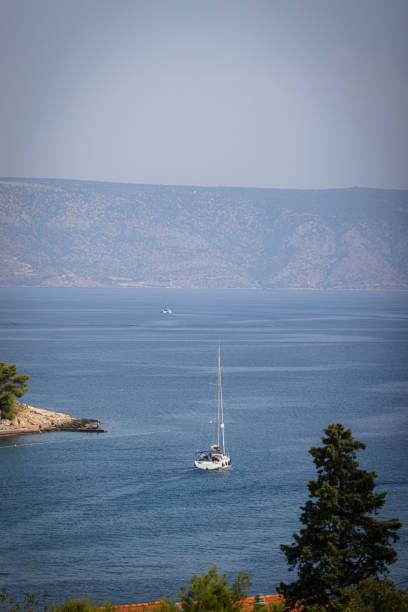 The boat is sailing on Adriatic Sea in cloudy weather.Hvar Island - Croatia.