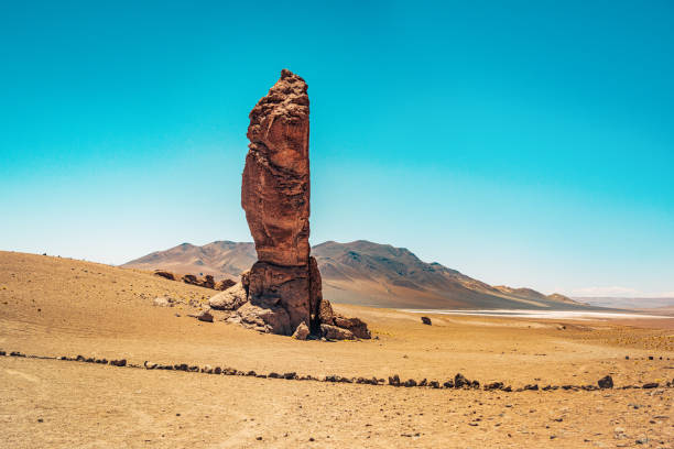 Majestic Rock Formation in the Atacama Desert, Chile A stunning rock formation stands tall against the clear blue sky in the arid Atacama Desert of Chile, showcasing the unique geological landscape. barron gorge national park stock pictures, royalty-free photos & images