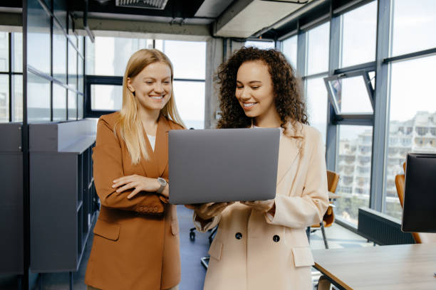 istock Happy business colleagues using laptop discussing idea 2170934492
