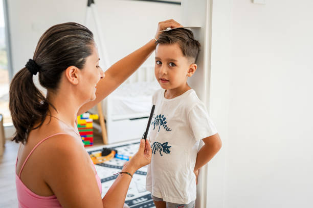 istock Happy Mother measuring son's height on door 2170936356