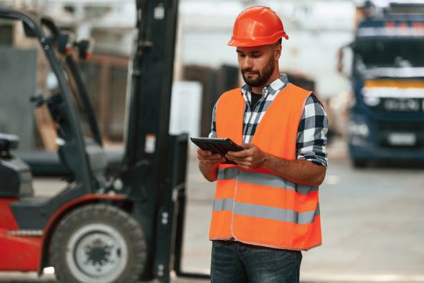 istock Manager is with digital tablet. Industrial worker in wooden warehouse 2170937420