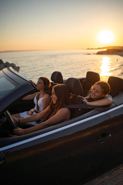 istock Three girls enjoy driving in a convertible 2170937802