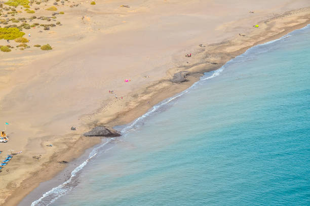 istock A beach with a blue ocean and a few people on it 2170939026