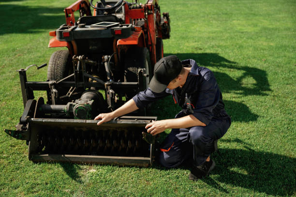 istock Checking the cutters. Man is with utility tractor with grass cutter and aerator equipment on the field 2170941390