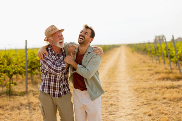 istock Two men stroll through a sunlit vineyard, sharing laughter and stories on a warm afternoon, surrounded by lush green vines 2170942117