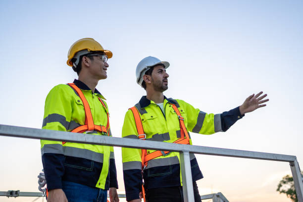 istock Diverse male technicians working to maintenance outdoors warehouse. Innovation engineer men wearing safety gear, work to develop environmental renewable clean energy outside storehouse factory plant. 2170942197