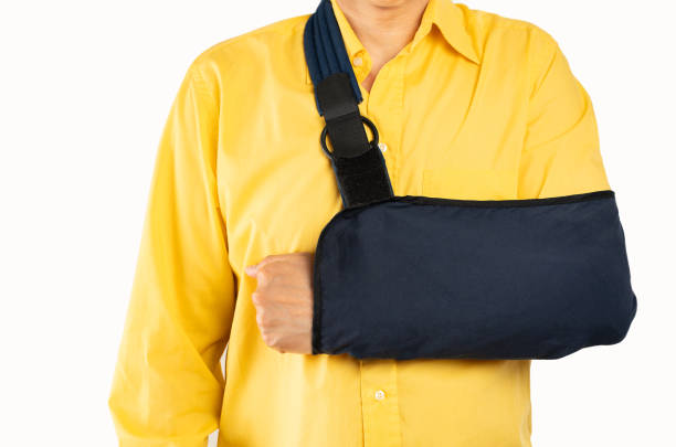 istock man wearing arm sling with yellow shirt 2170942996