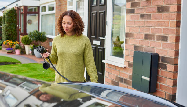 electric car charging at home stock photo