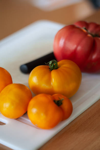 Tomatoes and knife on a cutting board