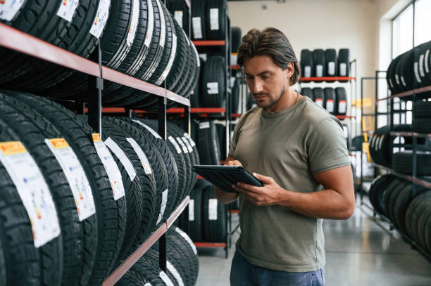 istock Notepad in hands. Man is in the tire fitting car service 2170943541