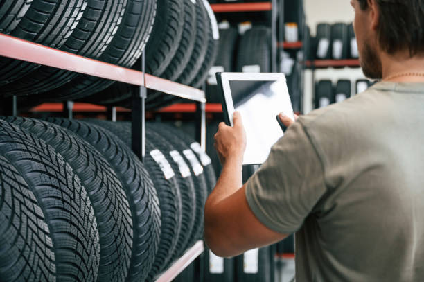 istock Copy space on the digital tablet. Man is in the tire fitting car service 2170943619