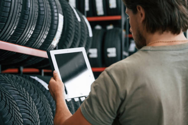 istock Copy space on the digital tablet. Man is in the tire fitting car service 2170943626