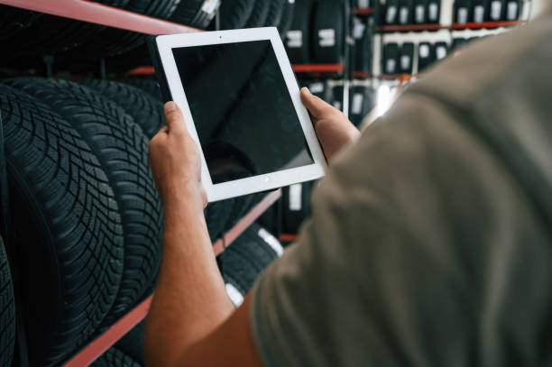 istock Copy space on the digital tablet. Man is in the tire fitting car service 2170943636