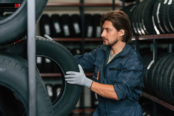 istock Man is in the tire fitting car service 2170943685