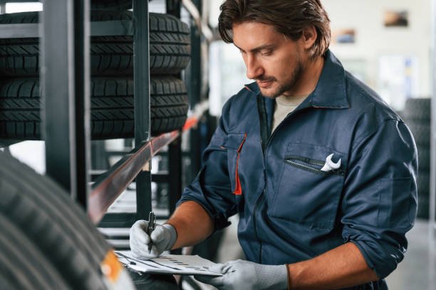 istock Writing the data into notepad. Man is in the tire fitting car service 2170943725