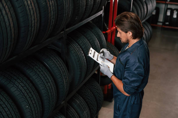istock Collecting information, counting, notepad. Man is in the tire fitting car service 2170943792