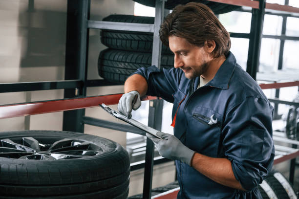 istock Writing the data into notepad. Man is in the tire fitting car service 2170943941