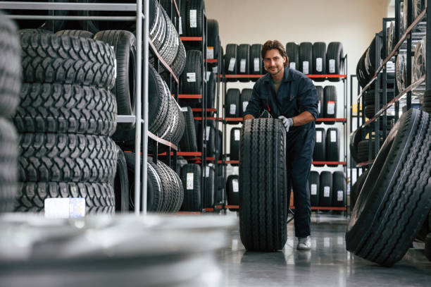 istock Rolling the wheel. Man is in the tire fitting car service 2170945091