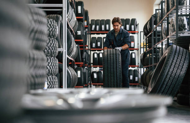 istock Rolling the wheel. Man is in the tire fitting car service 2170945092