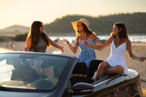 istock Girls having fun on road trip in car 2170945690