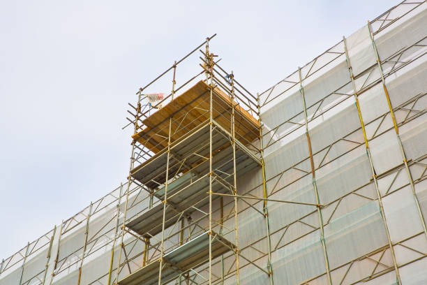 istock Metal scaffolding on a construction site built with prefabricated components to work safely on the facade of a building for the renovation of the plaster wall or realization of thermal insulation to improve the energy efficiency of the building 2170945760