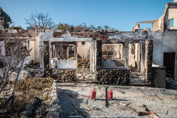 istock Portrait of a gutted building which has been devasted by a fire against a blue sky 2170947122