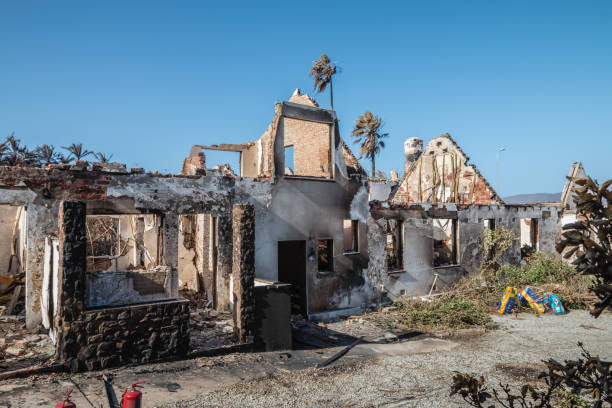 istock Portrait of a gutted building which has been devasted by a fire against a blue sky 2170947162